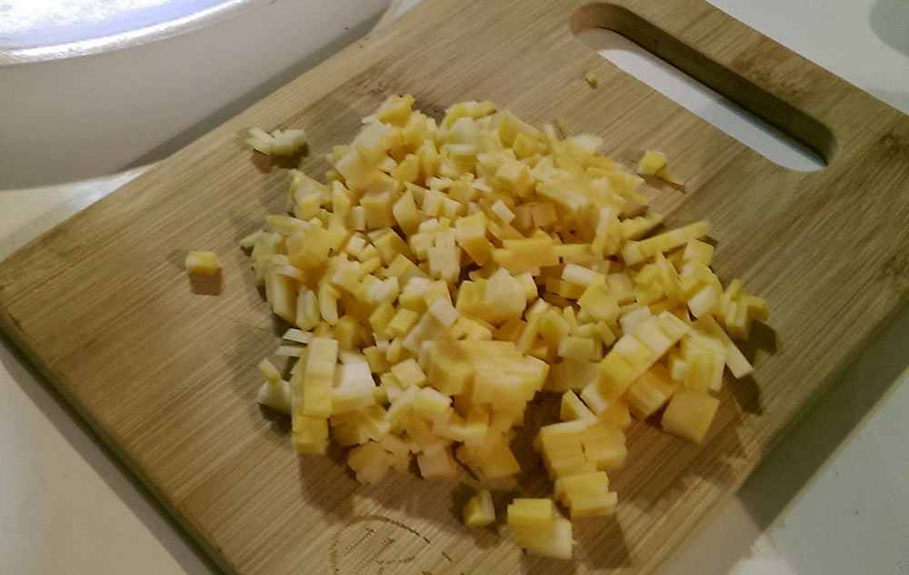 Diced/sliced cheese on a cutting board